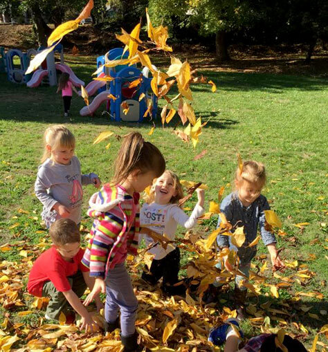Berry Bright Students Playing in Leaves